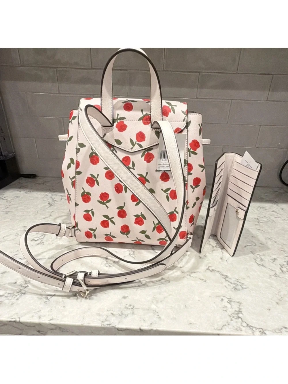 kate spade cream backpack with red floral print